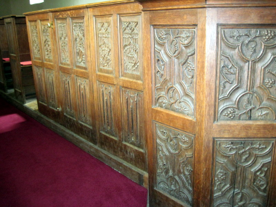 17. Panels around the pulpit with ornate Flemish carving.