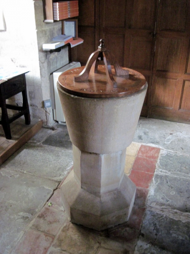 47. The old stone font with a 20th century cover.
