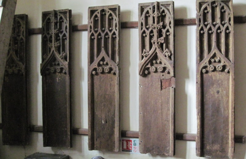 50. Five wooden panels with tracery, displayed in the vestry, are probably from a Perpendicular style pulpit.