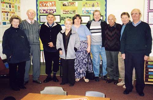 A group of former pupils and staff on a tour of the school.